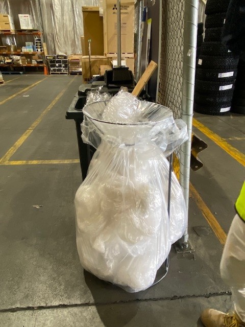 Heavy-duty industrial clear plastic bin liner to collect pallet wrap.